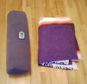 Blanket, bolster, and timer for savasana